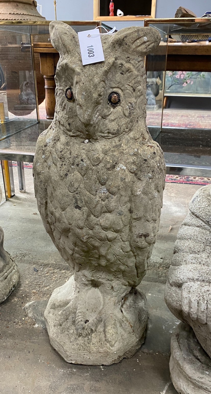 A reconstituted stone garden ornament modelled as a standing owl, height 71cm